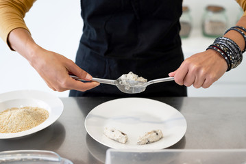 Close up of woman hands cooking homemade croquettes at home