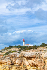 Fototapeta na wymiar famous historic lighthouse of Carvoeiro at the wild coast of the Algarve at Carvoeiro