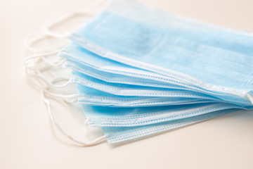 Blue medical masks, as protection against viruses, on white background, selective focus, concept, covid19