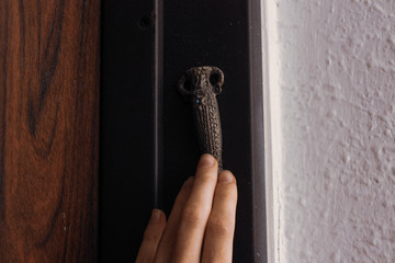 A woman is touching a metal mezuzah in Israel
