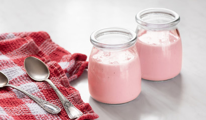 fresh natural homemade strawberry yogurt in a glass jar