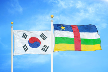 South Korea and Central African Republic  two flags on flagpoles and blue cloudy sky