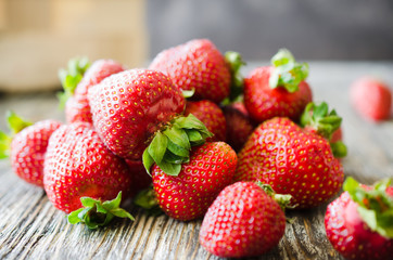 Fresh ripe strawberries on a wooden background. Organic juicy berries.