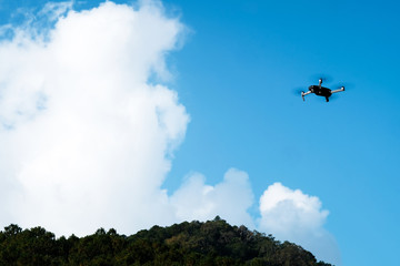 The drone is flying in the air waiting to be controlled.
