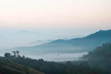 A beautiful landscape of mountains in the morning and winter fog. Chiang Rai, Thailand.