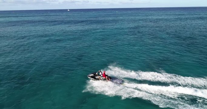 Slow motion, Drone footage, life guard on jet ski performing rescue operation off the coast of, Hawaii, in crystal clear water