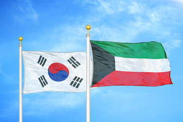 South Korea and Kuwait two flags on flagpoles and blue cloudy sky