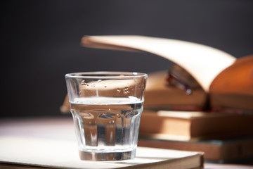 still of lemon water with book and glasses
