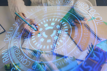 Double exposure of hands making notes background with technology and digital coding huds. Data learning concept.