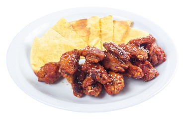 chicken wings in spicy sauce. popular pub dish. beautiful junk food concept. isolated on a white plate.