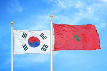 South Korea and Morocco two flags on flagpoles and blue cloudy sky