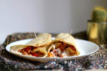 Homemade tortillas with chicken, vegetables and sauce. Selective focus.