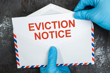 Person Holding Eviction Notice In Envelope - obrazy, fototapety, plakaty