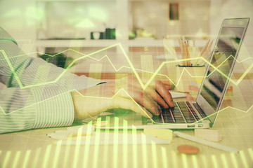 Double exposure of stock market graph with man working on laptop on background. Concept of financial analysis.