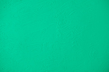 Bright green wall background with embossed abstract pattern 
