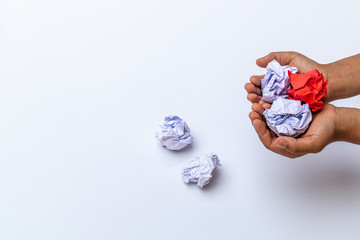 Hand holding crumpled paper ball on white background. - fail creativity concept.