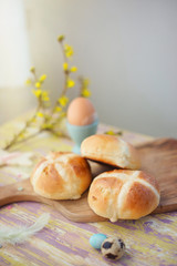 Easter breakfast table with fresh hot-cross buns