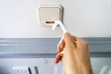 Man Using Tool To Press Button