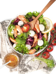 food photography of diet dish, red fish salad (salmon) with vegetables, a mix salad leaves (lettuce) and balls of mozzarella cheese and mustard-honey dressing, isolated on white background, top view