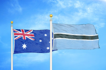 Australia and Botswana two flags on flagpoles and blue cloudy sky