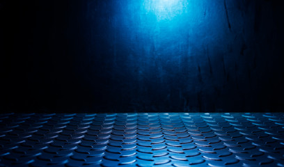 The metal floor in the dark With light shining down Black wall background