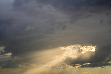 Fototapeta na wymiar Sunset sky covered with dramatic storm puffy clouds before rain.