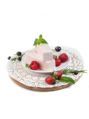 food photography of pink fruit pastille with garden berries and mint closeup isolated on white background