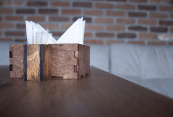 wooden brown box with a napkin is on the table.