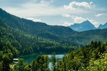 Panoramic view of the Alps and the beautiful Alpsee lake. Photograph taken in Schwangau, Bavaria, Germany.