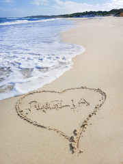 Italian beach with heart and text on the sand PUGLIA