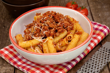 Macaroni pasta with Bolognese ragu, traditional italian pasta with tomato sauce, meat and vegetables.