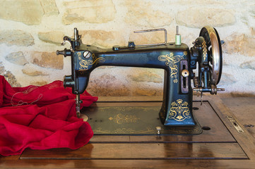 Vintage sewing machine and red fabric