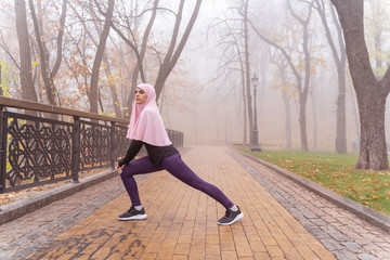 Sporty lady doing lunges outdoors stock photo