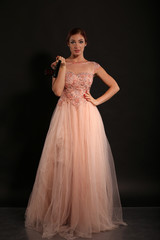 Fototapeta premium Cute girl in pink dress with Makarov pistol