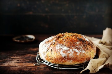 Homemade bread with black sesame seeds on a dark wooden table