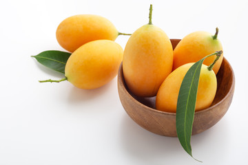 Marian plum, plum mango in wooden bowl