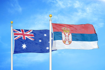 Australia and Serbia two flags on flagpoles and blue cloudy sky