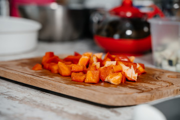 Chopped red bell peppers on a wooden board