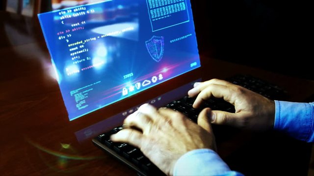 Man typing computer keyboard with program code on virtual hologram screen on desk. Programmer work at home, pc programming, coding and cyber technology futuristic concept. Hand shake camera.