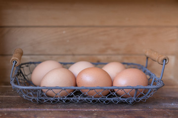 Brown organic freshly collected farm eggs in vintage box . Easter Composition in Rustic Authentic Style. Selected focus. Copy Space