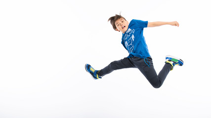 Happy child jumps high on isolated background