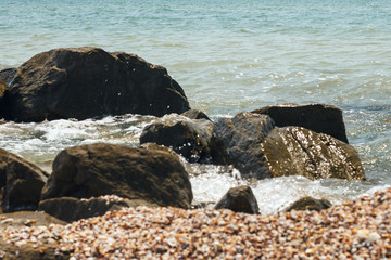 Sea coast. wet stones, waves. Background