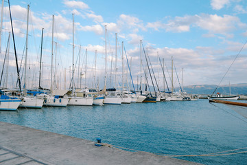 Giant yachts at pier in small harbor of old European city. Summer travel concept