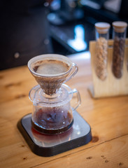 Barista pours water into the filter with coffee