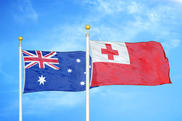 Fototapeta premium Australia and Tonga two flags on flagpoles and blue cloudy sky