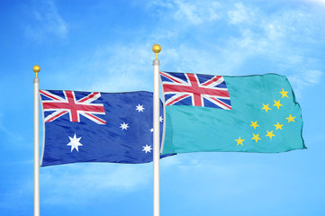 Australia and Tuvalu two flags on flagpoles and blue cloudy sky