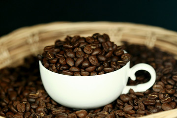 Coffee beans in a white cup , close up , top view