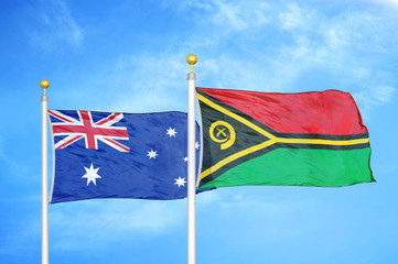 Australia and Vanuatu two flags on flagpoles and blue cloudy sky