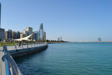 Fototapeta na wymiar View of Abu Dhabi Cornish during the day tome with beautiful blue sky and blue sea. Luxury lifestyle, tourism, United Arab Emirates, Abu Dhabi life,