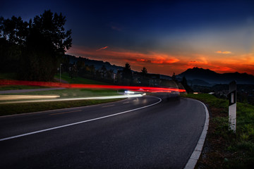 streaks of car lights during sun down